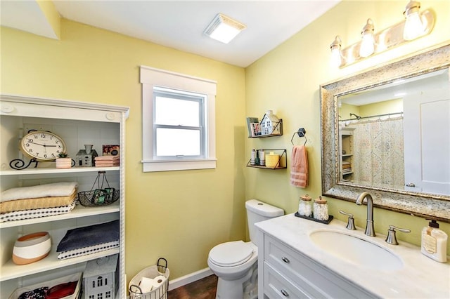 123 Willow Ct, Raceland, LA 70394 - full bath featuring vanity, toilet, baseboards, and wood finished floors