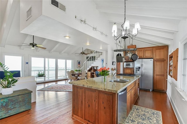 329 Carr Dr, Slidell, LA 70458 - kitchen featuring stainless steel appliances, beam ceiling, ceiling fan, brown cabinets, and a sink