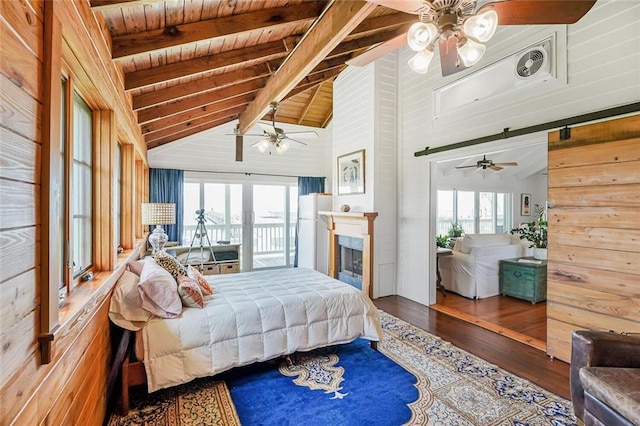329 Carr Dr, Slidell, LA 70458 - bedroom with wood ceiling, wood finished floors, wood walls, a ceiling fan, and a fireplace