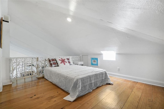 329 Carr Dr, Slidell, LA 70458 - bedroom with baseboards, hardwood / wood-style floors, vaulted ceiling, and multiple windows