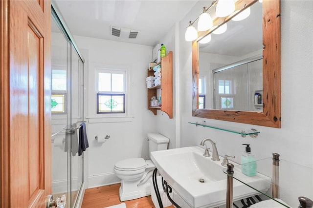 329 Carr Dr, Slidell, LA 70458 - full bath featuring toilet, a shower stall, wood finished floors, and a sink