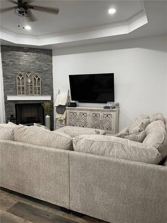 246 Betty Dr, Montz, LA 70068 - living room featuring a raised ceiling, wood finished floors, a stone fireplace, a ceiling fan, and recessed lighting