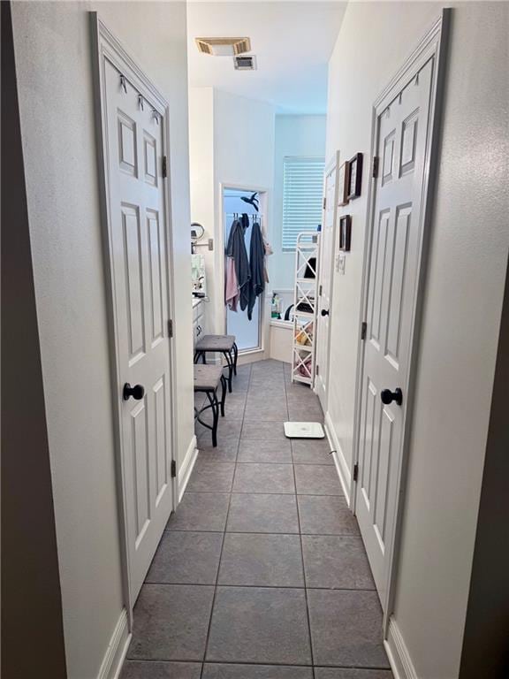 246 Betty Dr, Montz, LA 70068 - hallway with dark tile patterned floors and baseboards