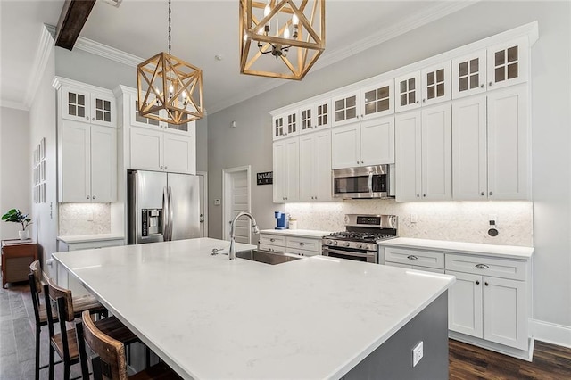 668 Highlands Dr, Slidell, LA 70458 - kitchen featuring appliances with stainless steel finishes, a chandelier, a sink, ornamental molding, and a large island