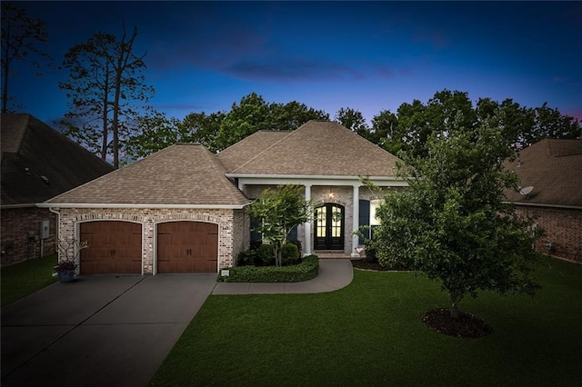 668 Highlands Dr, Slidell, LA 70458 - view of front of property with french doors, an attached garage, and a yard