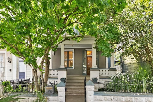 1322 Prytania St, New Orleans, LA 70130 - view of front of house featuring a porch and a fenced front yard