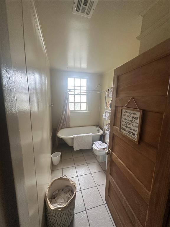 70911 Evelina St, New Orleans, LA 70114 - bathroom featuring a freestanding tub and tile patterned floors