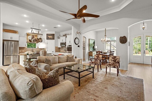 511 Lakewood Northshore Dr, Covington, LA 70433 - living room with arched walkways, a chandelier, ornamental molding, ceiling fan, and recessed lighting
