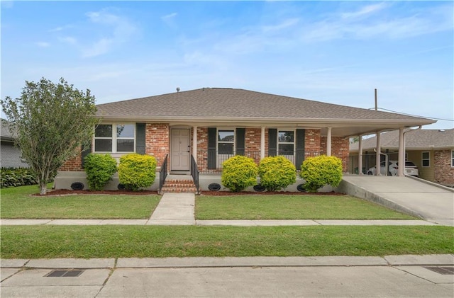 1924 Cammie Ave, Metairie, LA 70003 - view of front of home featuring a front yard, driveway, a carport, and brick siding