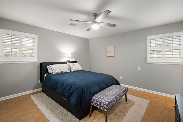 1924 Cammie Ave, Metairie, LA 70003 - bedroom featuring multiple windows, baseboards, and light wood-type flooring