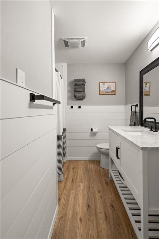 1924 Cammie Ave, Metairie, LA 70003 - full bathroom featuring vanity, wood finished floors, and toilet