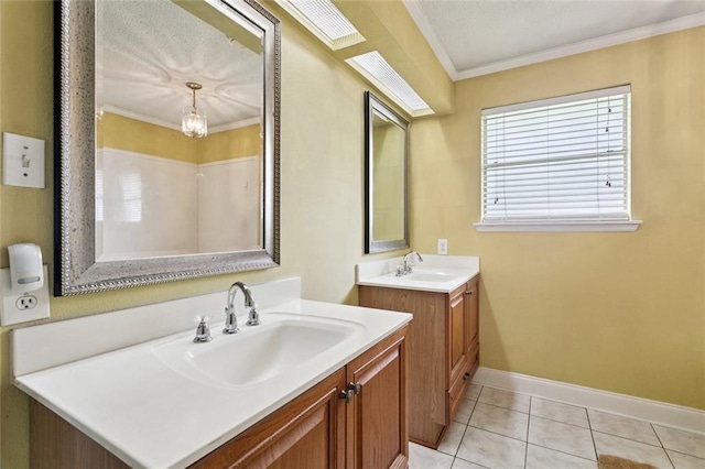 118 Weatherly Cv, Slidell, LA 70458 - full bath with ornamental molding, two vanities, tile patterned flooring, baseboards, and a chandelier