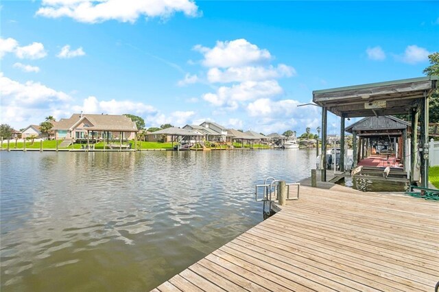 118 Weatherly Cv, Slidell, LA 70458 - dock area featuring boat lift, a residential view, and a water view