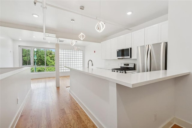 822 N Rampart St Unit 301, New Orleans, LA 70116 - kitchen featuring appliances with stainless steel finishes, baseboards, white cabinetry, light countertops, and light wood-style floors