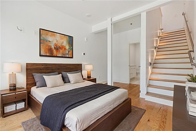 822 N Rampart St Unit 301, New Orleans, LA 70116 - bedroom featuring light wood-style flooring and ensuite bathroom