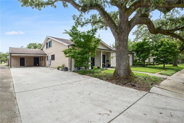 788 Amethyst St, New Orleans, LA 70124 - view of front of property featuring concrete driveway, a carport, and a front lawn