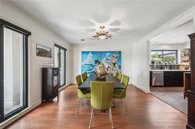 788 Amethyst St, New Orleans, LA 70124 - dining area featuring healthy amount of natural light, a chandelier, wood finished floors, crown molding, and baseboards