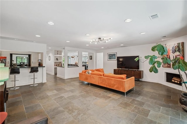 788 Amethyst St, New Orleans, LA 70124 - living area featuring recessed lighting, stone finish flooring, baseboards, and a chandelier