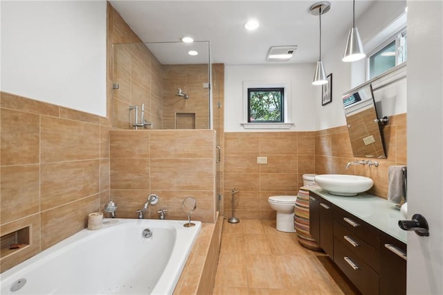 788 Amethyst St, New Orleans, LA 70124 - bathroom with tile walls, tiled shower, tiled bath, vanity, and toilet