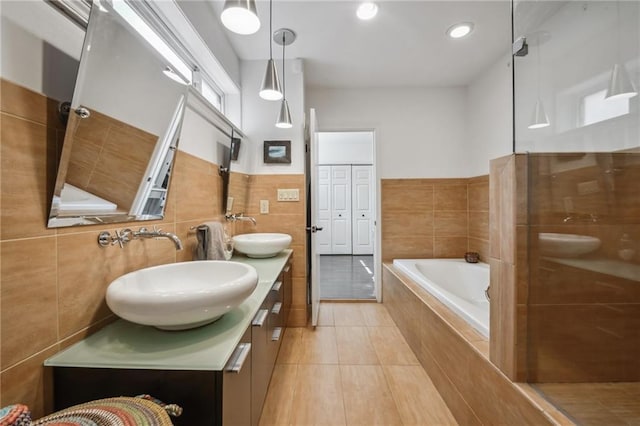 788 Amethyst St, New Orleans, LA 70124 - full bath featuring a bath, double vanity, tile walls, tile patterned flooring, and recessed lighting