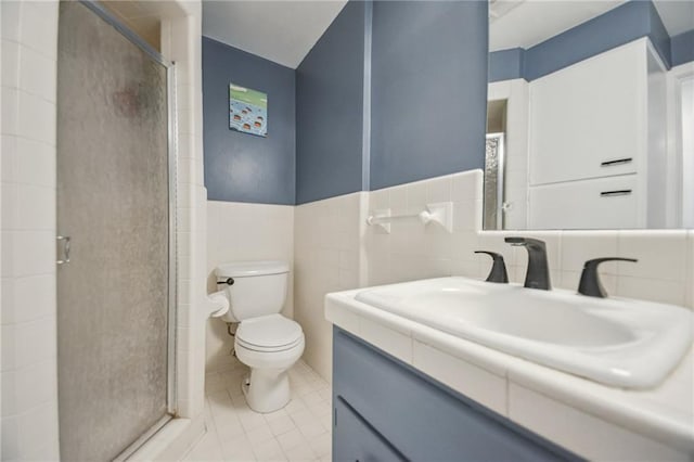 788 Amethyst St, New Orleans, LA 70124 - bathroom with toilet, vanity, a stall shower, tile walls, and tile patterned flooring