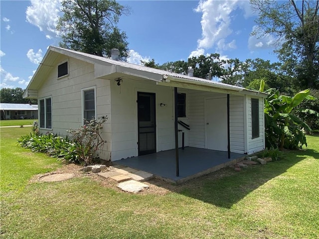 63070 Oak St, Roseland, LA 70456 - rear view of house featuring a patio area and a lawn