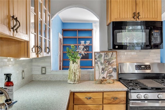 830103 Belfast St, New Orleans, LA 70118 - kitchen with black microwave, gas stove, arched walkways, tasteful backsplash, and glass insert cabinets