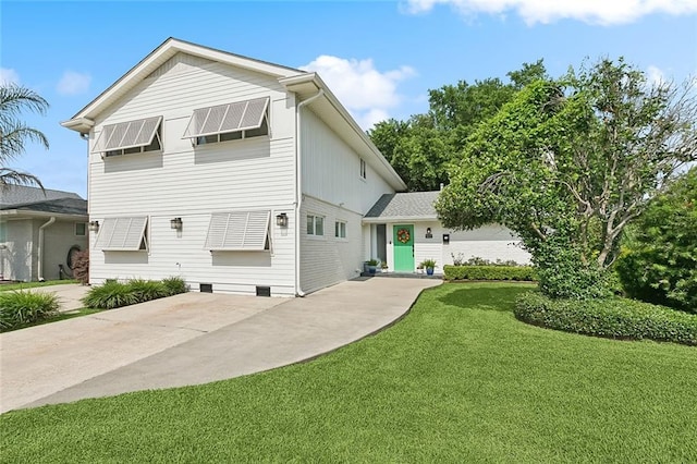 613 Andrews Ave, Metairie, LA 70005 - back of house with a lawn, a patio, and driveway