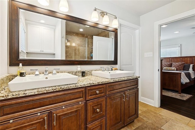 613 Andrews Ave, Metairie, LA 70005 - bathroom featuring double vanity, baseboards, ensuite bath, a tile shower, and recessed lighting