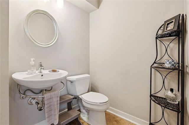 613 Andrews Ave, Metairie, LA 70005 - half bathroom featuring toilet, baseboards, and tile patterned floors