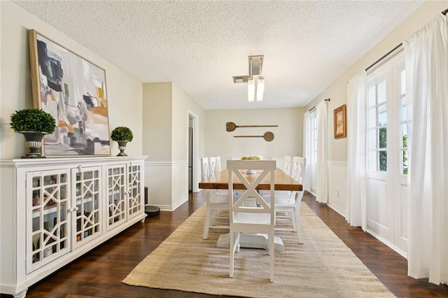 4212 Pommard Dr, Kenner, LA 70065 - dining area featuring wood finished floors, a textured ceiling, and a wainscoted wall