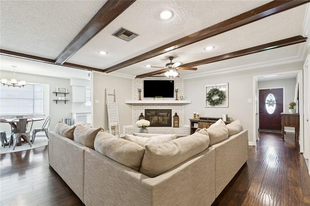 4212 Pommard Dr, Kenner, LA 70065 - living area featuring beam ceiling, a brick fireplace, ceiling fan, a chandelier, and a textured ceiling