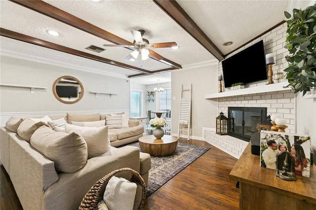 4212 Pommard Dr, Kenner, LA 70065 - living area with beamed ceiling, a textured ceiling, a ceiling fan, dark wood-style floors, and a brick fireplace