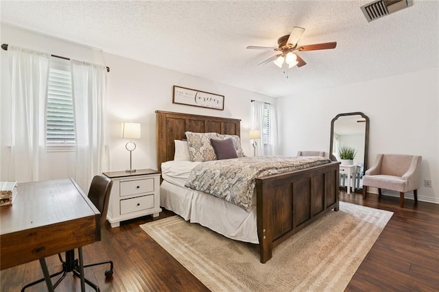 4212 Pommard Dr, Kenner, LA 70065 - bedroom featuring a textured ceiling, dark wood-style floors, arched walkways, and a ceiling fan