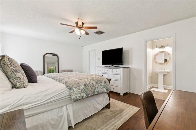 4212 Pommard Dr, Kenner, LA 70065 - bedroom featuring a textured ceiling, dark wood-type flooring, ceiling fan, and ensuite bath