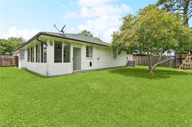 4212 Pommard Dr, Kenner, LA 70065 - back of property featuring a playground, brick siding, cooling unit, and roof with shingles