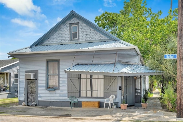 8301 Belfast St Unit 8303, New Orleans, LA 70118 - view of front of house featuring metal roof and a wall mounted AC