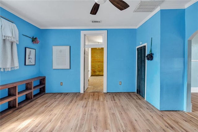8301 Belfast St Unit 8303, New Orleans, LA 70118 - unfurnished bedroom featuring wood finished floors, ornamental molding, arched walkways, and ceiling fan