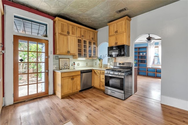 8301 Belfast St Unit 8303, New Orleans, LA 70118 - kitchen with appliances with stainless steel finishes, decorative backsplash, a sink, light countertops, and an ornate ceiling
