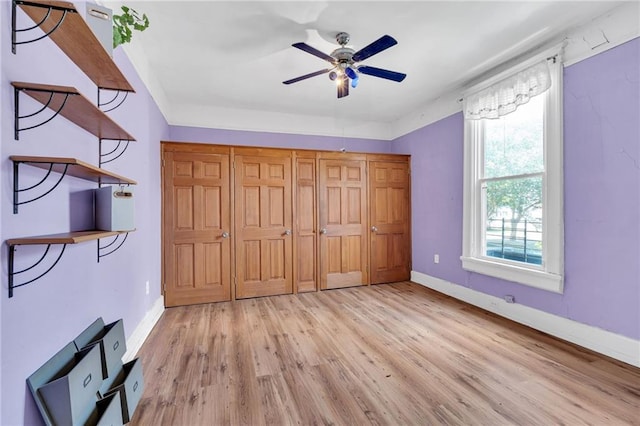 8301 Belfast St Unit 8303, New Orleans, LA 70118 - unfurnished bedroom with light wood-type flooring, baseboards, and ceiling fan