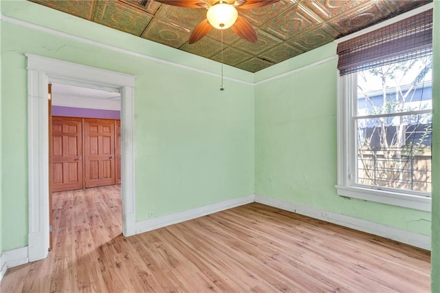 8301 Belfast St Unit 8303, New Orleans, LA 70118 - unfurnished room featuring an ornate ceiling, light wood-type flooring, plenty of natural light, ceiling fan, and baseboards