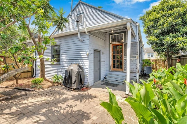 8301 Belfast St Unit 8303, New Orleans, LA 70118 - back of property with entry steps, a patio area, and central air condition unit