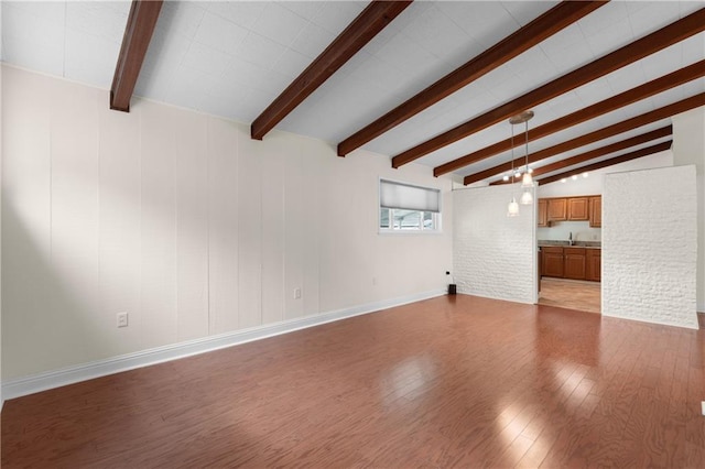 6416 Nora St, Metairie, LA 70003 - unfurnished living room featuring wood finished floors and a sink