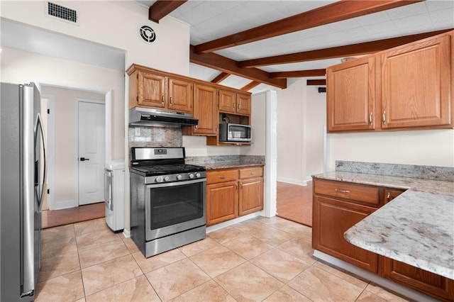 6416 Nora St, Metairie, LA 70003 - kitchen featuring stainless steel appliances, under cabinet range hood, light stone counters, decorative backsplash, and light tile patterned floors