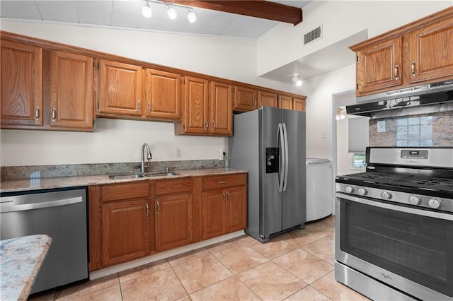 6416 Nora St, Metairie, LA 70003 - kitchen featuring stainless steel appliances, under cabinet range hood, brown cabinets, light stone counters, and light tile patterned flooring