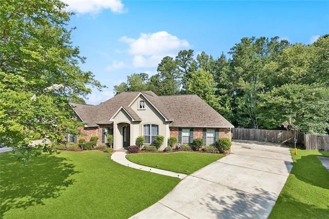 1061 Tallow Tree Dr, Mandeville, LA 70448 - view of front of home featuring concrete driveway, stucco siding, roof with shingles, and brick siding