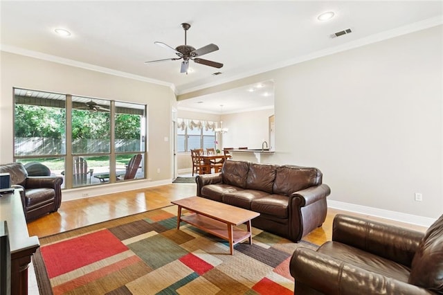 1061 Tallow Tree Dr, Mandeville, LA 70448 - living area with wood finished floors, ceiling fan, baseboards, recessed lighting, and ornamental molding
