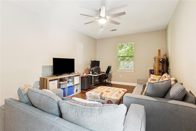 1061 Tallow Tree Dr, Mandeville, LA 70448 - living area with wood finished floors, an office area, a ceiling fan, and baseboards