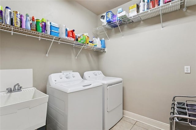 1061 Tallow Tree Dr, Mandeville, LA 70448 - washroom with washing machine and dryer, light tile patterned floors, and baseboards