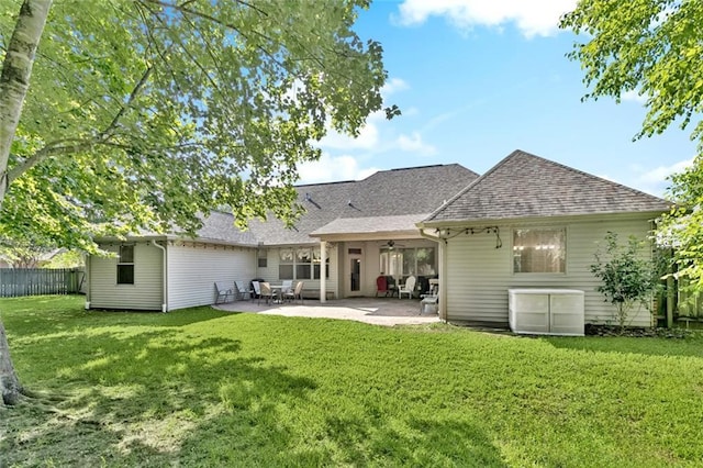 1061 Tallow Tree Dr, Mandeville, LA 70448 - back of property featuring a ceiling fan, roof with shingles, and a patio area